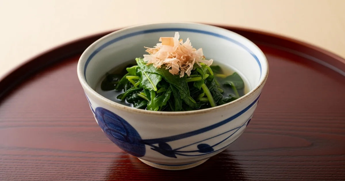 Japanese ohitashi dish made with green tea leaves in a ceramic bowl with dashi